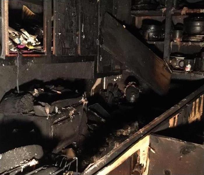 Image of kitchen severely damaged with soot and smoke damage after a fire