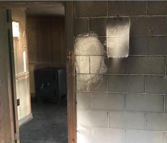 Image of walls and floors of local office damaged with soot and smoke damage