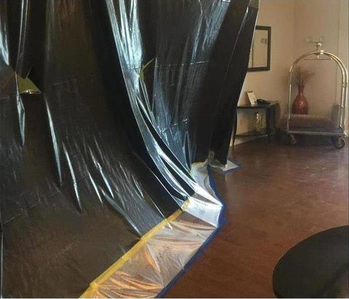 Image of containment set up in hotel hallway after flooding