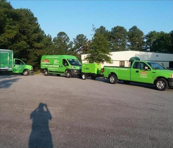 Green vehicles packed and ready for storm cleanup.