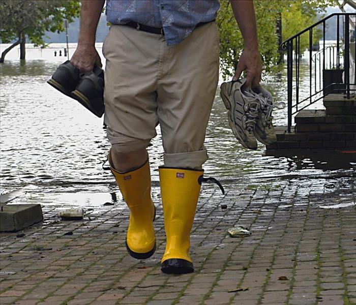 Man walking in a flooded street.