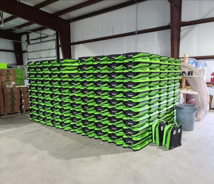 Stacks of SERVPRO equipment are lined up. 